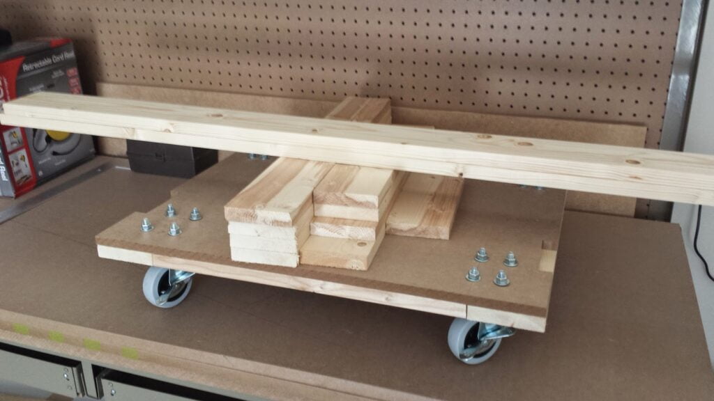 Arcade cabinet base with boards needed to construct frame.
