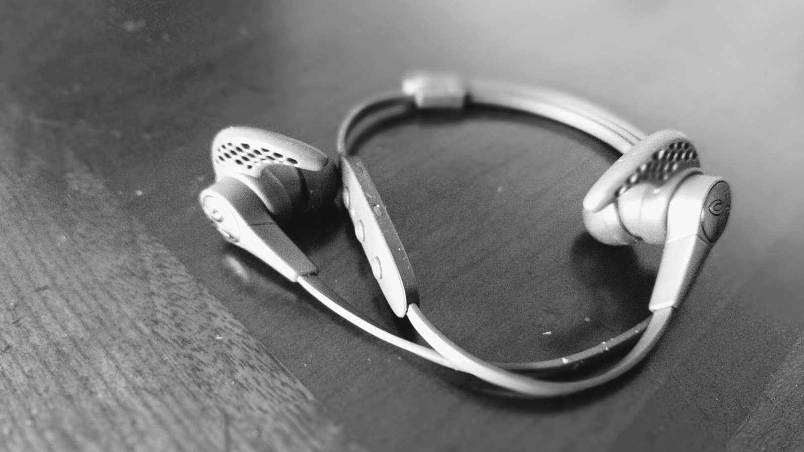 Black & white photo of a pair of Jaybird X3 earbuds