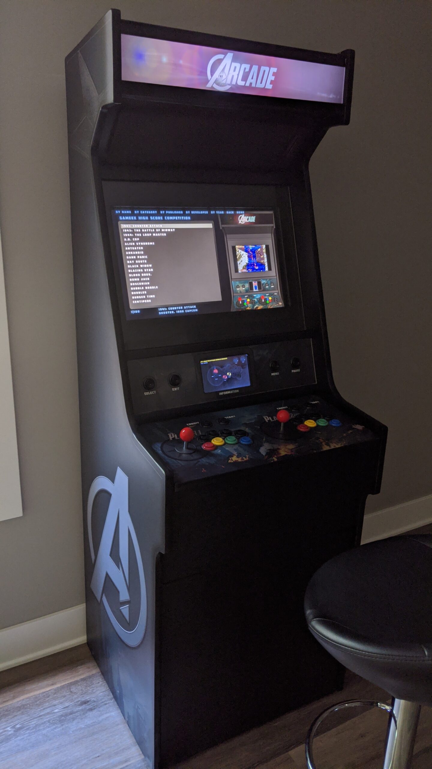 Finished arcade cabinet, powered up with the GameEx frontend visible on the screen.