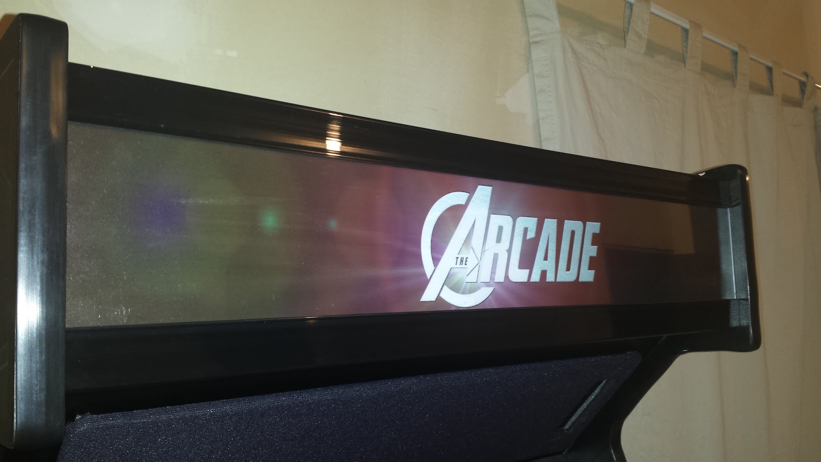 Unlit arcade marquee. Text on the marquee reads "The Arcade", with the "A" styled like the "A" in the Avengers logo.