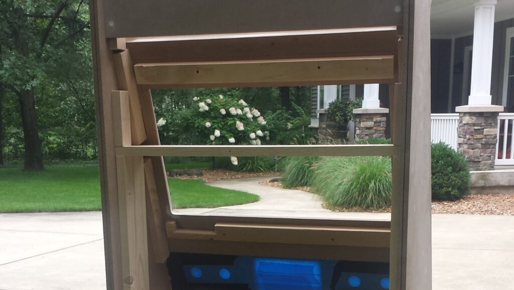 View of back of the screen mounting area. Furring strips are attached directly above & below where the monitor will rest. A section is cut out to leave room for the buttons on the bottom.