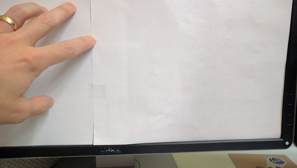 Multiple sheets of paper have been taped together to completely fill the screen area of a computer monitor